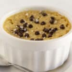 A microwave chocolate chip cookie with flaky sea salt and a spoon.
