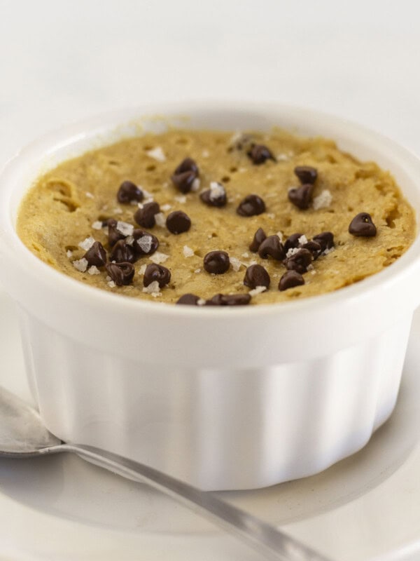 A microwave chocolate chip cookie with flaky sea salt and a spoon.