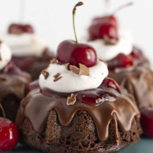 Mini black forest cakes with cherry pie filling, whipped topping and chocolate shavings.