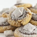 Muddy Buddy Cookies on a white cake plate.