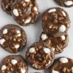 A dozen rocky road cookies on a white tray.