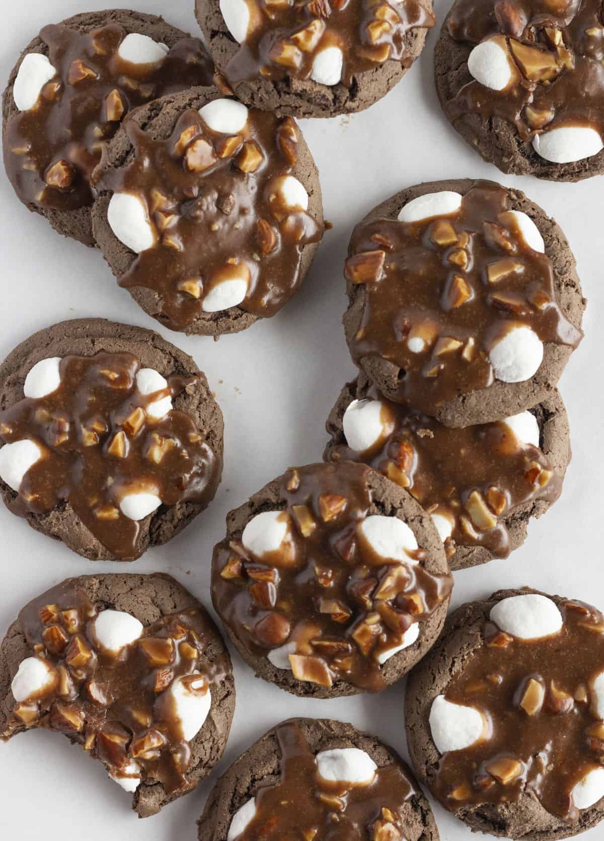 A dozen rocky road cookies on a white tray.