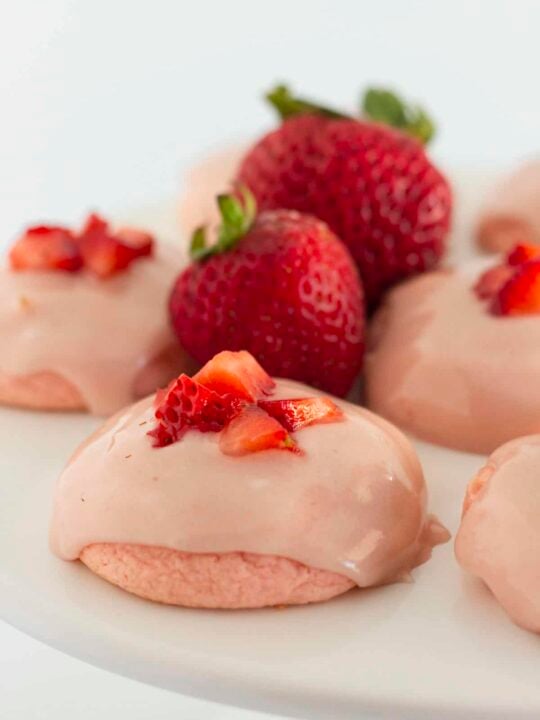Strawberry cake mix cookies on a white cake plate.