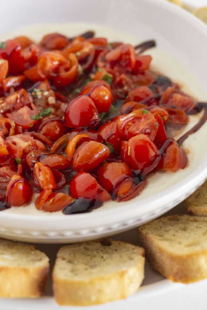 Fresh homemade bruschetta dip on creamy ricotta.