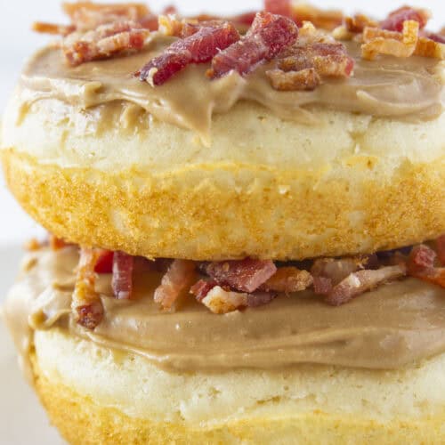 Two maple bacon donuts stacked on each other.