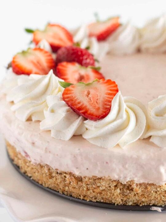 A fresh strawberry no bake cheesecake that is ready to serve.
