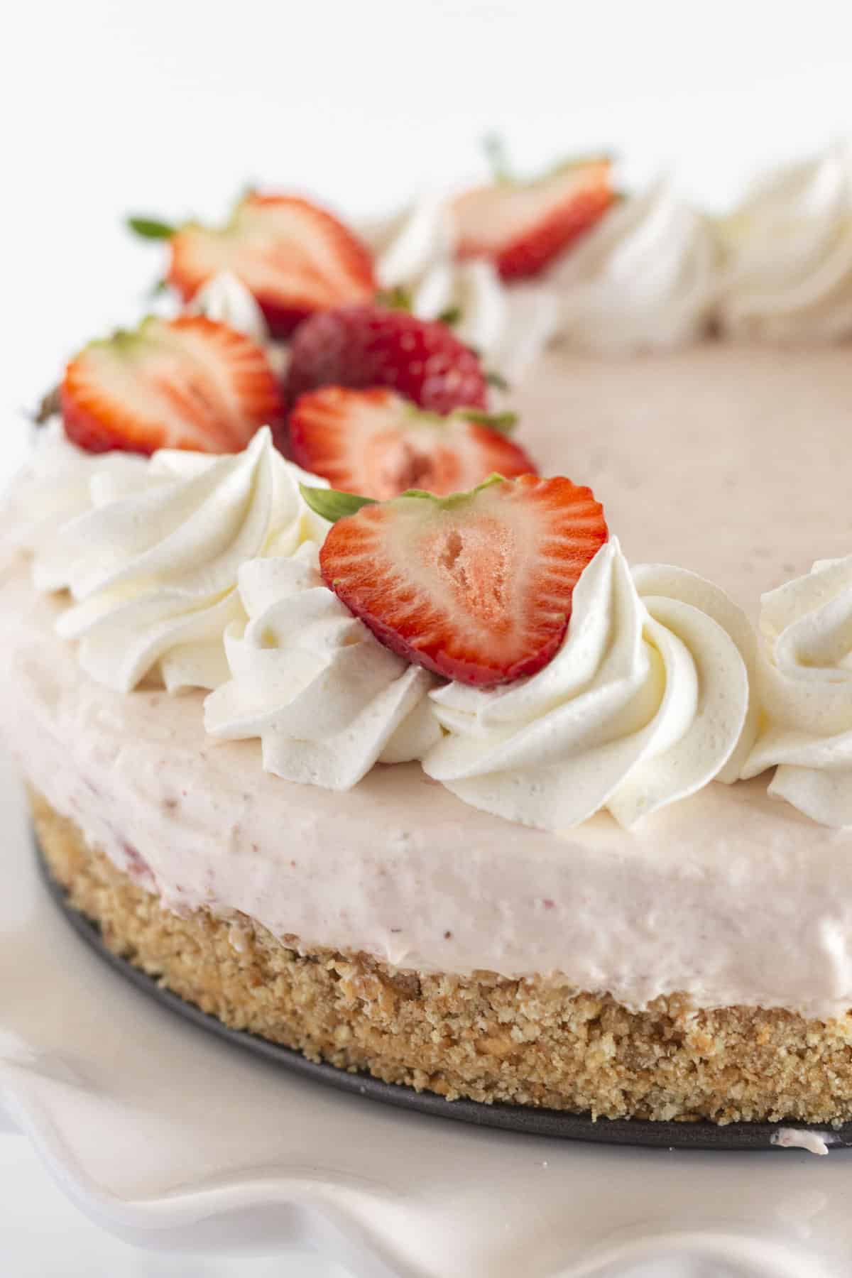 A fresh strawberry cheesecake that is ready to serve.