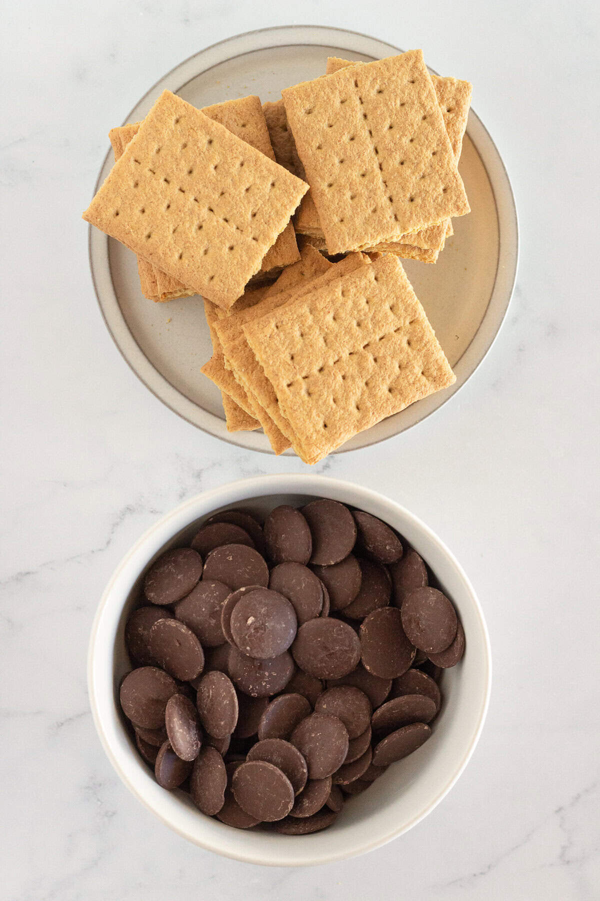 Graham crackers and melting chocolate to make homemade chocolate covered graham crackers.