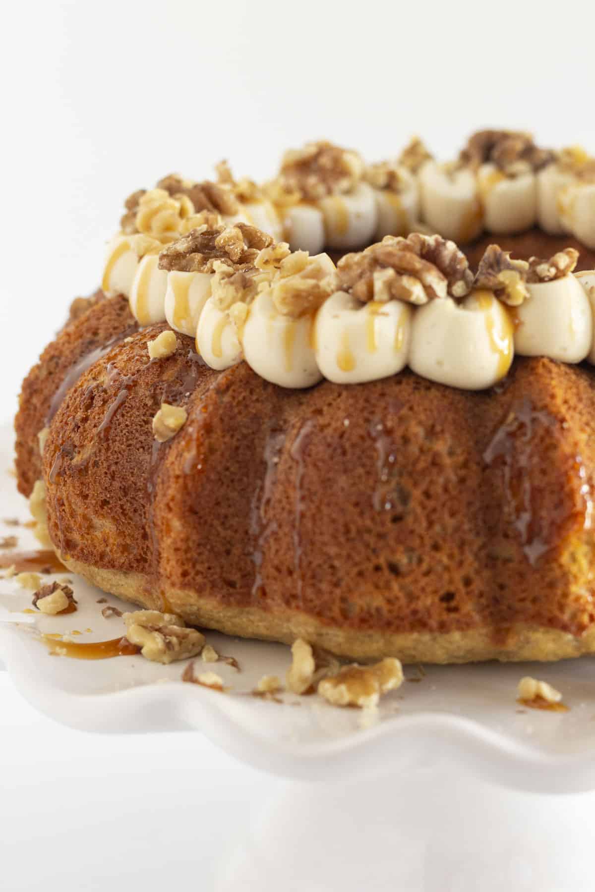 A whole banana and walnut cake with caramel frosting.