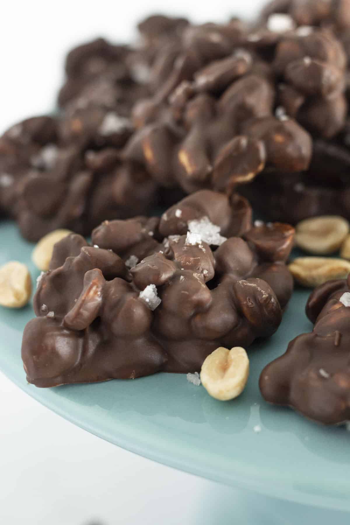 Chocolate covered peanuts with sea salt on a cake plate.