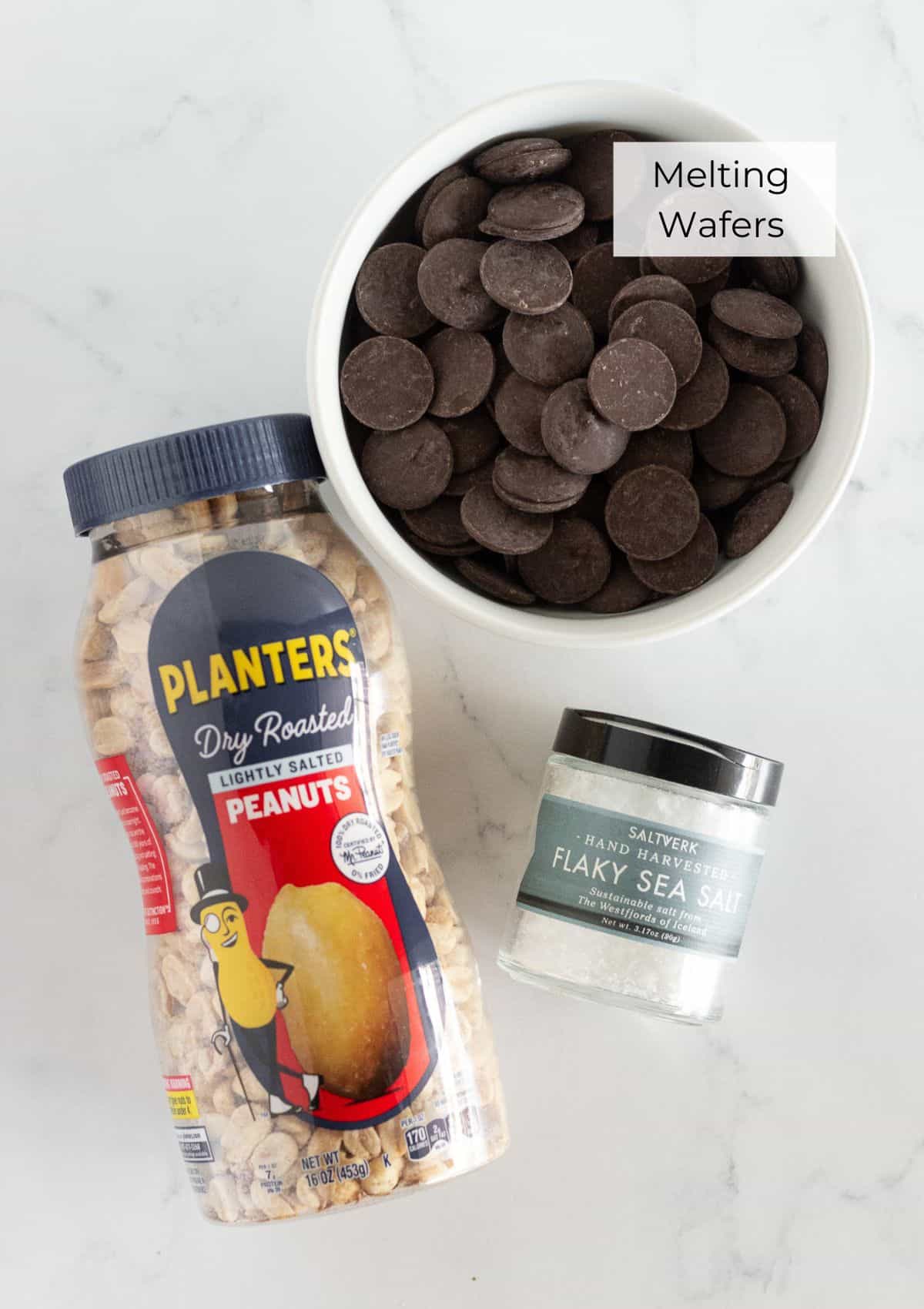 The ingredients needed to make chocolate covered peanuts.