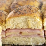 Serving brown sugar and ham sliders on a tray.