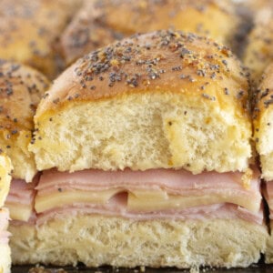 Serving brown sugar and ham sliders on a tray.
