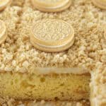 Golden Oreo Cake with cookies baked inside and topped with them.