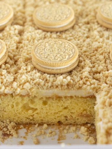 Golden Oreo Cake with cookies baked inside and topped with them.