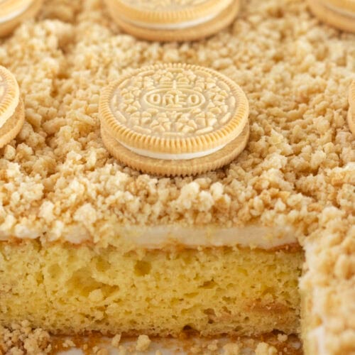 Golden Oreo Cake with cookies baked inside and topped with them.