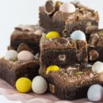 Fudgy Mini Egg Brownies on a pink cake plate.