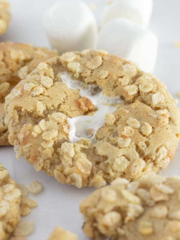 Rice krispie cookies on a white tray with large marshmallows.