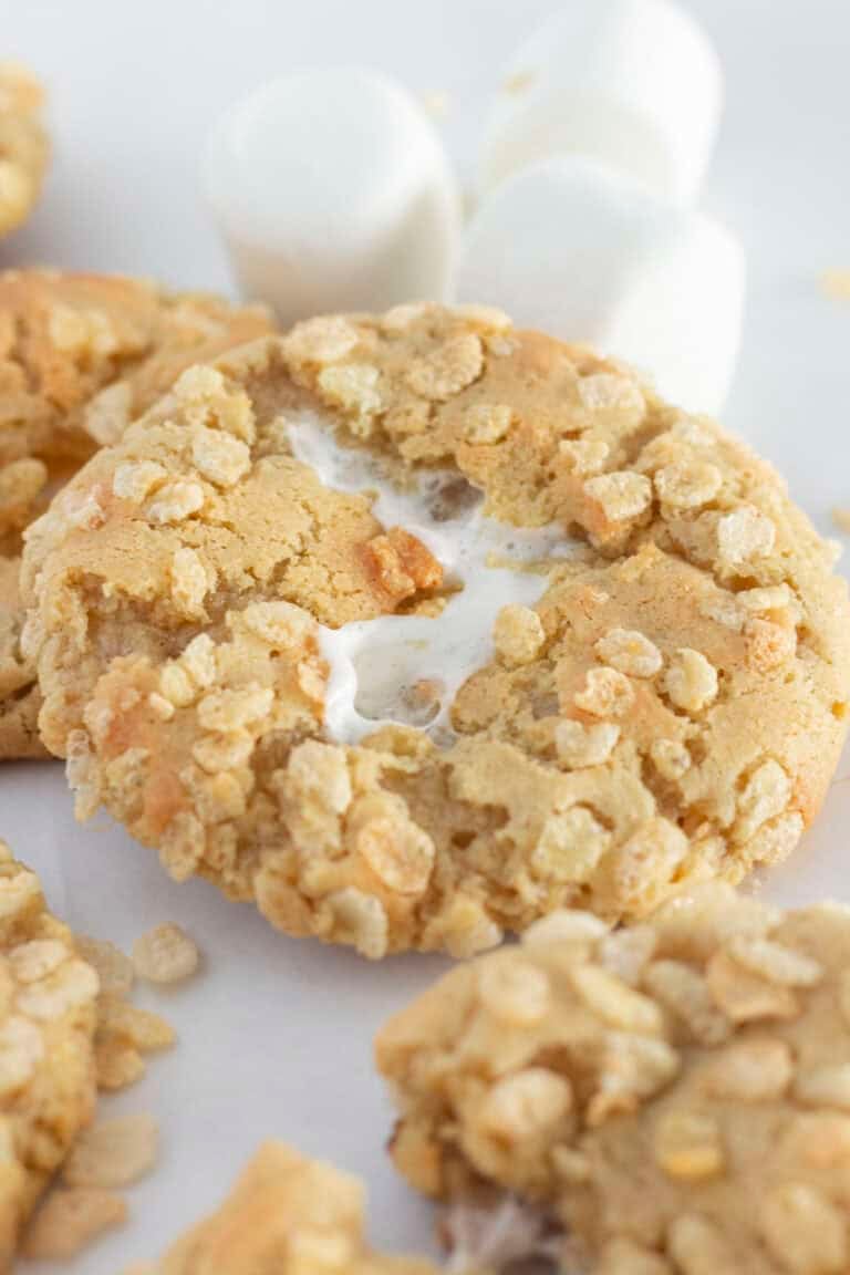 Rice krispie cookies on a white tray with large marshmallows.