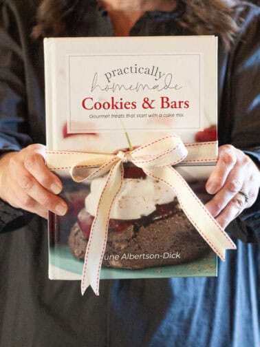June holding her Practically Homemade Cookies & Bars cookbook.