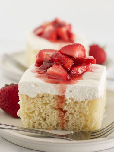 Two slices of vanilla sheet cake that starts with a cake mix.