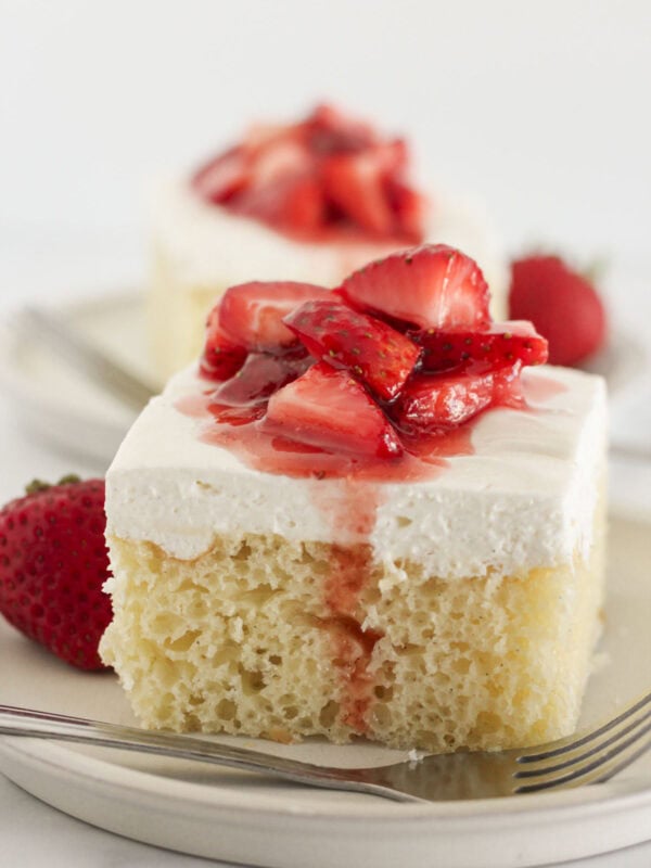 Two slices of vanilla sheet cake that starts with a cake mix.