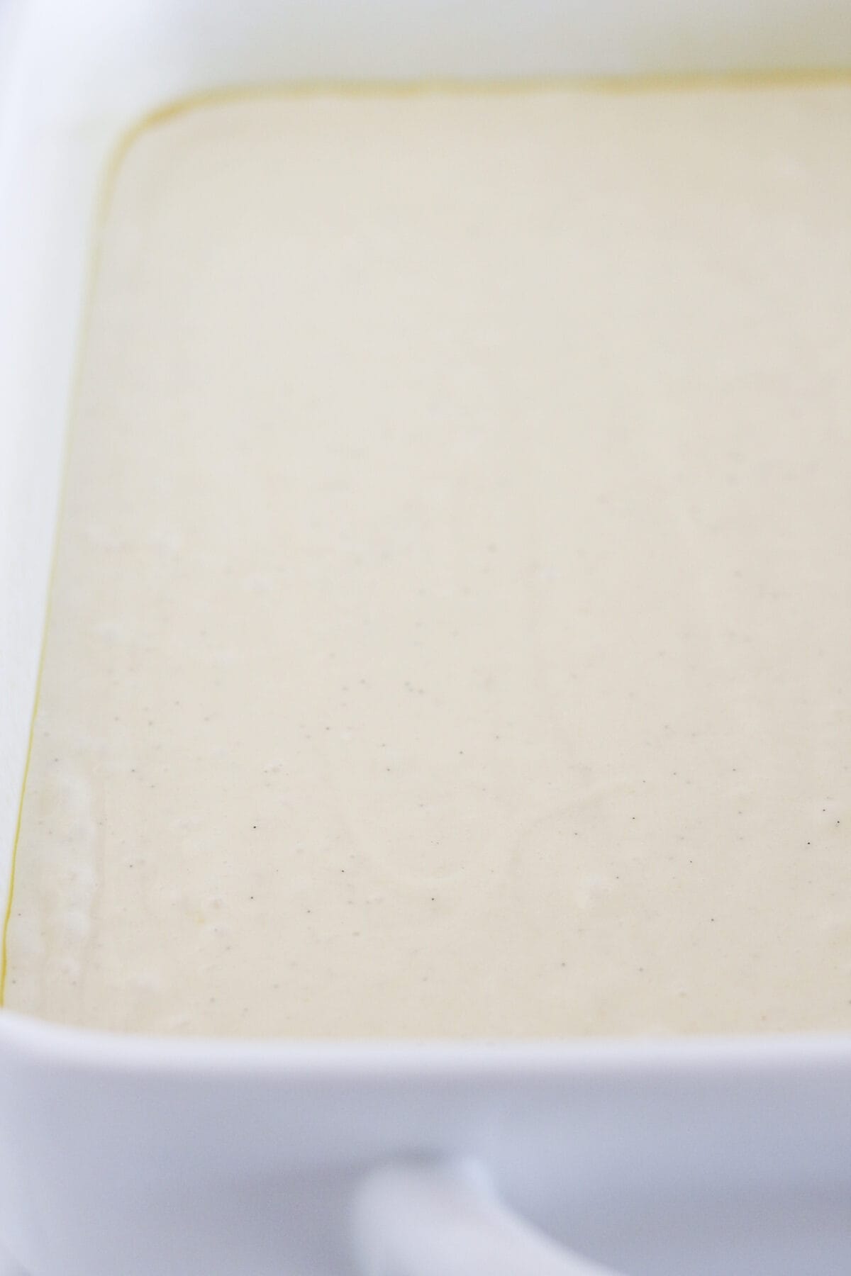 Pouring the cake batter into the prepared pan.