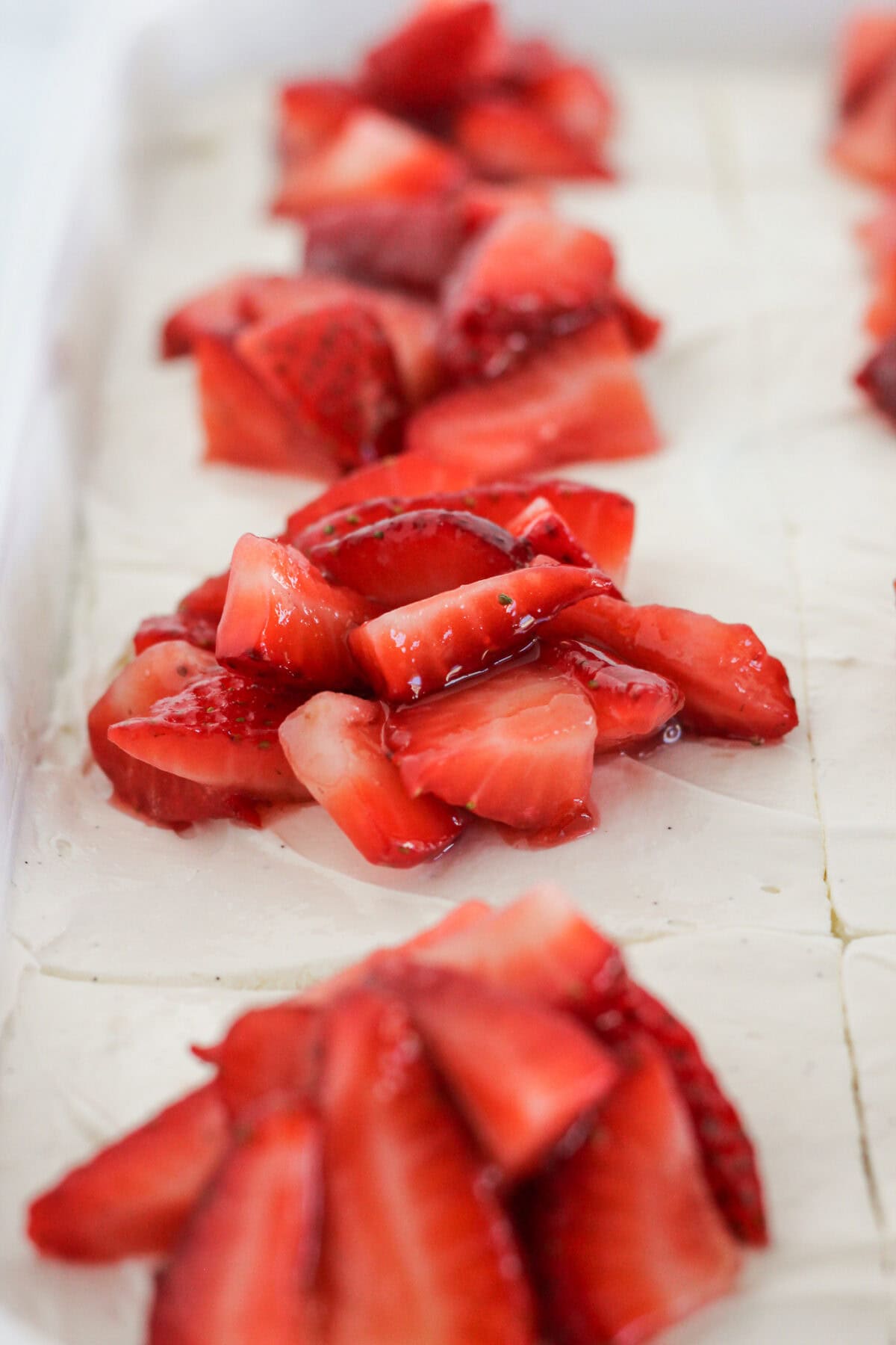Topping the cake with fresh strawberries.
