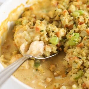 Serving chicken and stuffing casserole from a dish.