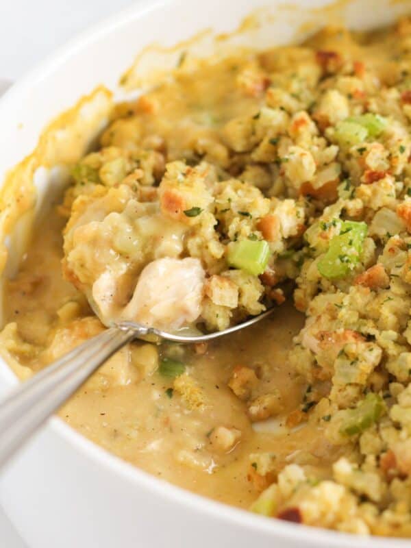 Serving chicken and stuffing casserole from a dish.