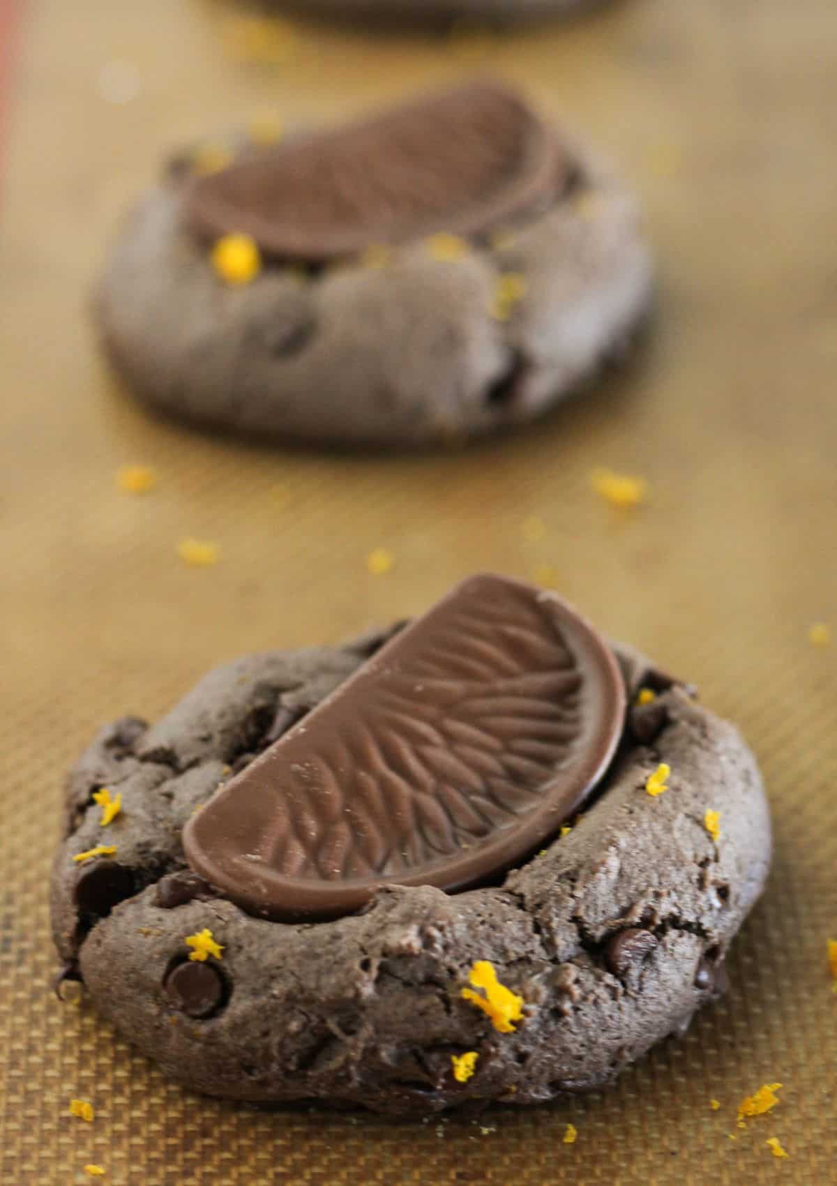 Finishing the cookies with candy and orange zest.