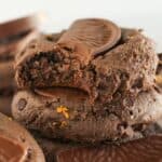 Stacks of chocolate orange cookies with a bite taken from one.