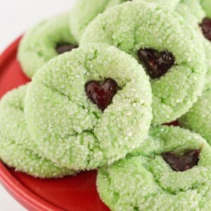 Grinch cake mix cookies on a red cake plate.
