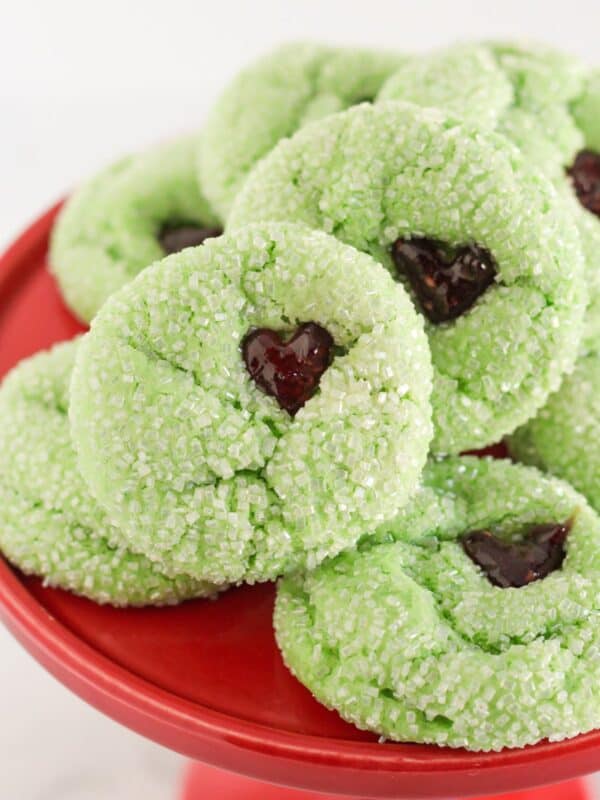 Grinch cake mix cookies on a red cake plate.