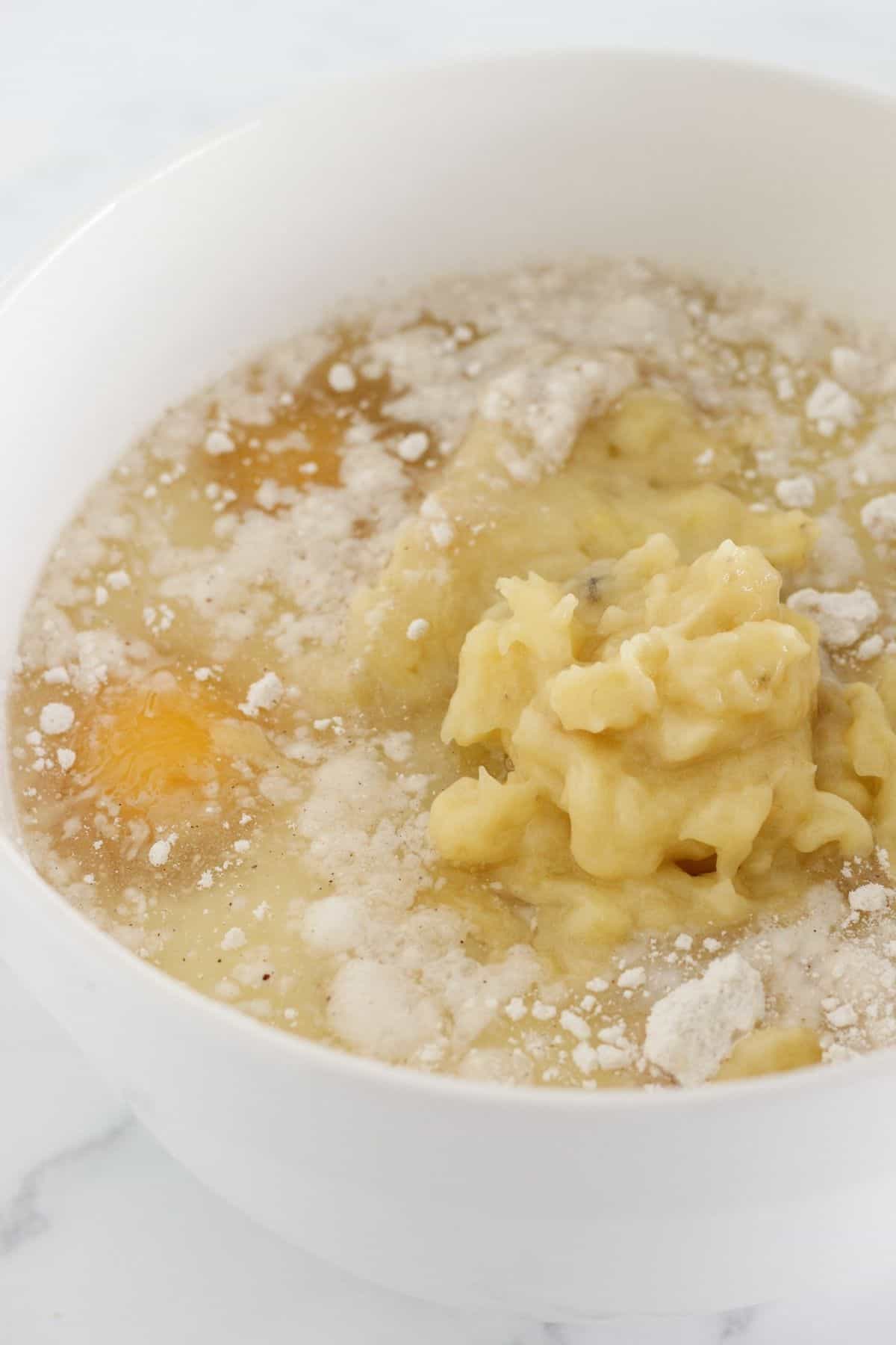 Combining ingredients for banana sheet cake batter.