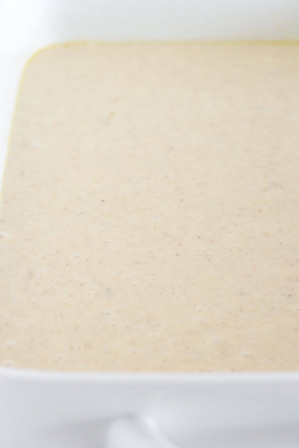 Banana cake batter poured into a prepared pan.