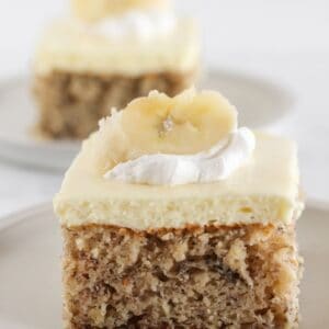 Two slices of banana sheet cake with a cake mix