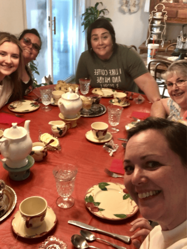 Family sat around a well set table.