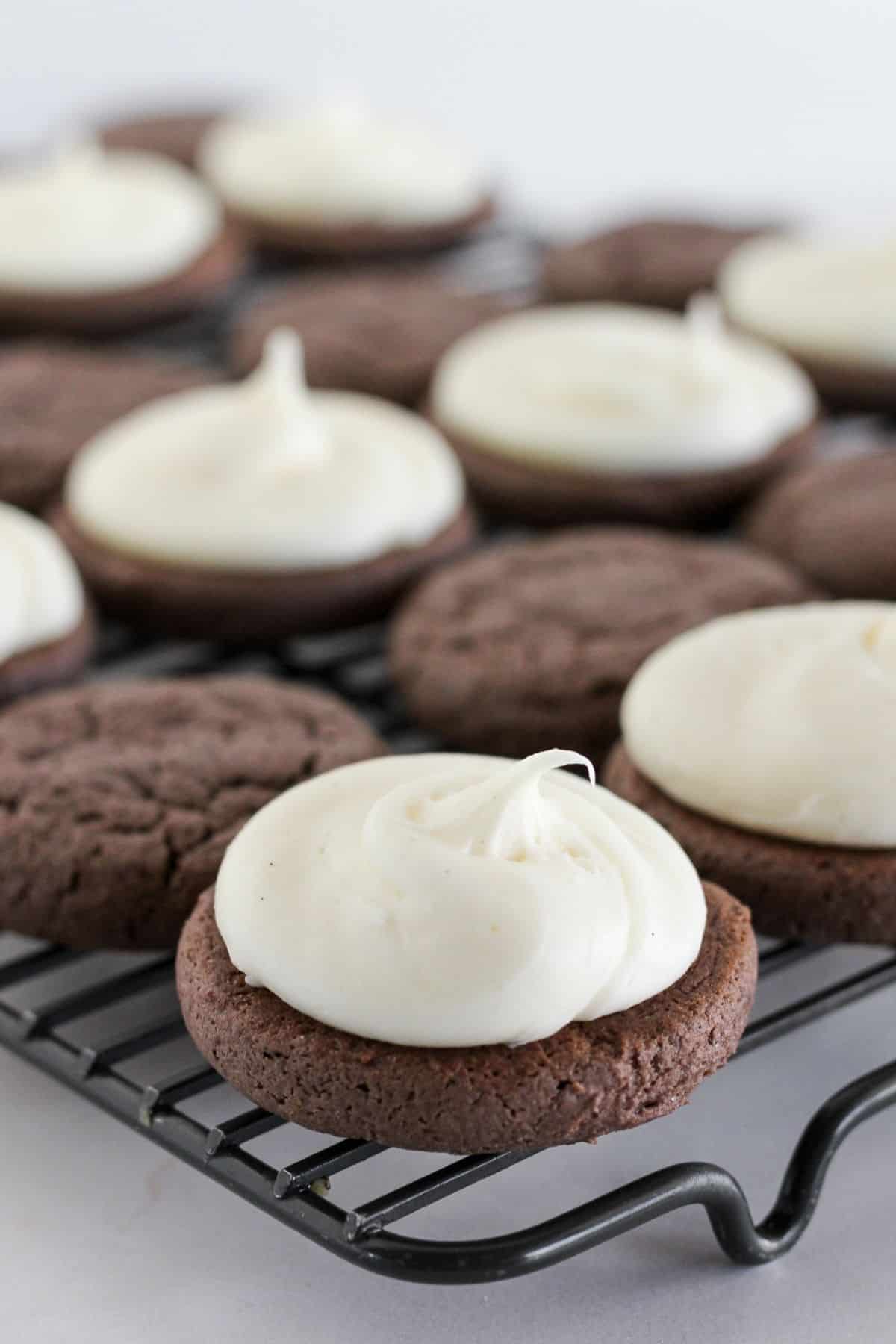 Adding frosting to half of the sandwich cookies.