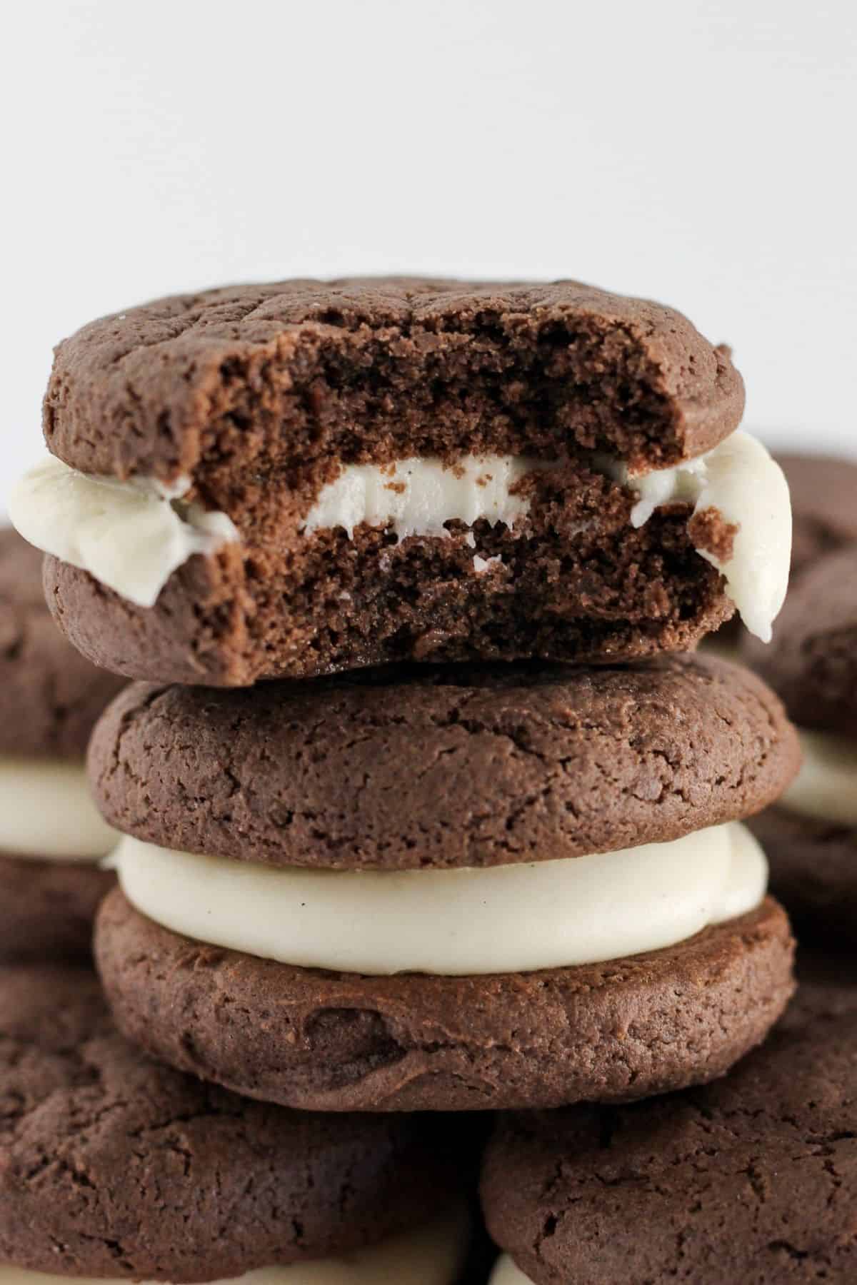 Chocolate sandwich cookies stacked.