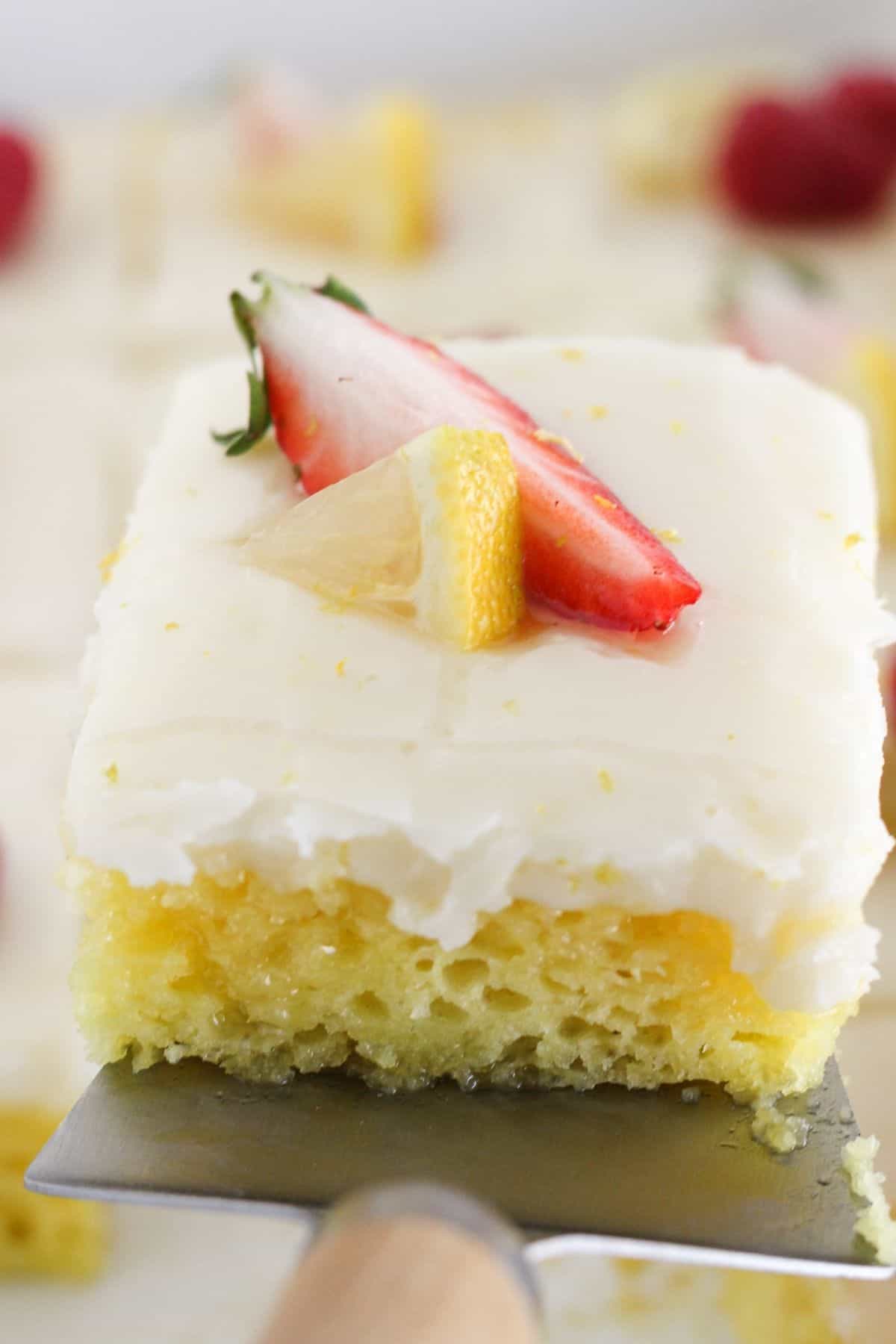 Removing a piece of lemon cake from pan.