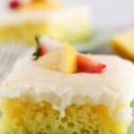 Lemon sheet cake squares on green plates.