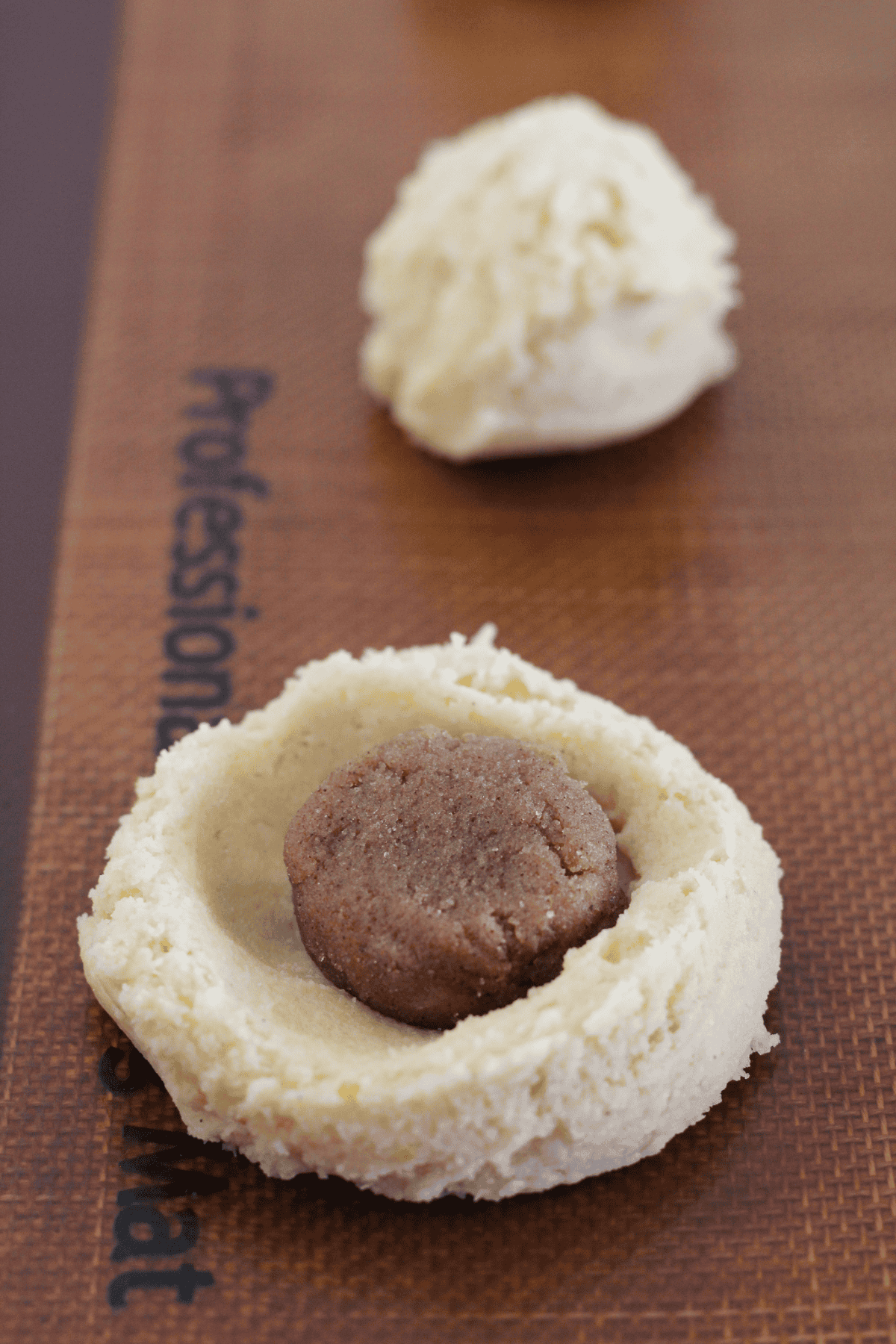 Adding cinnamon filling to cookie dough.