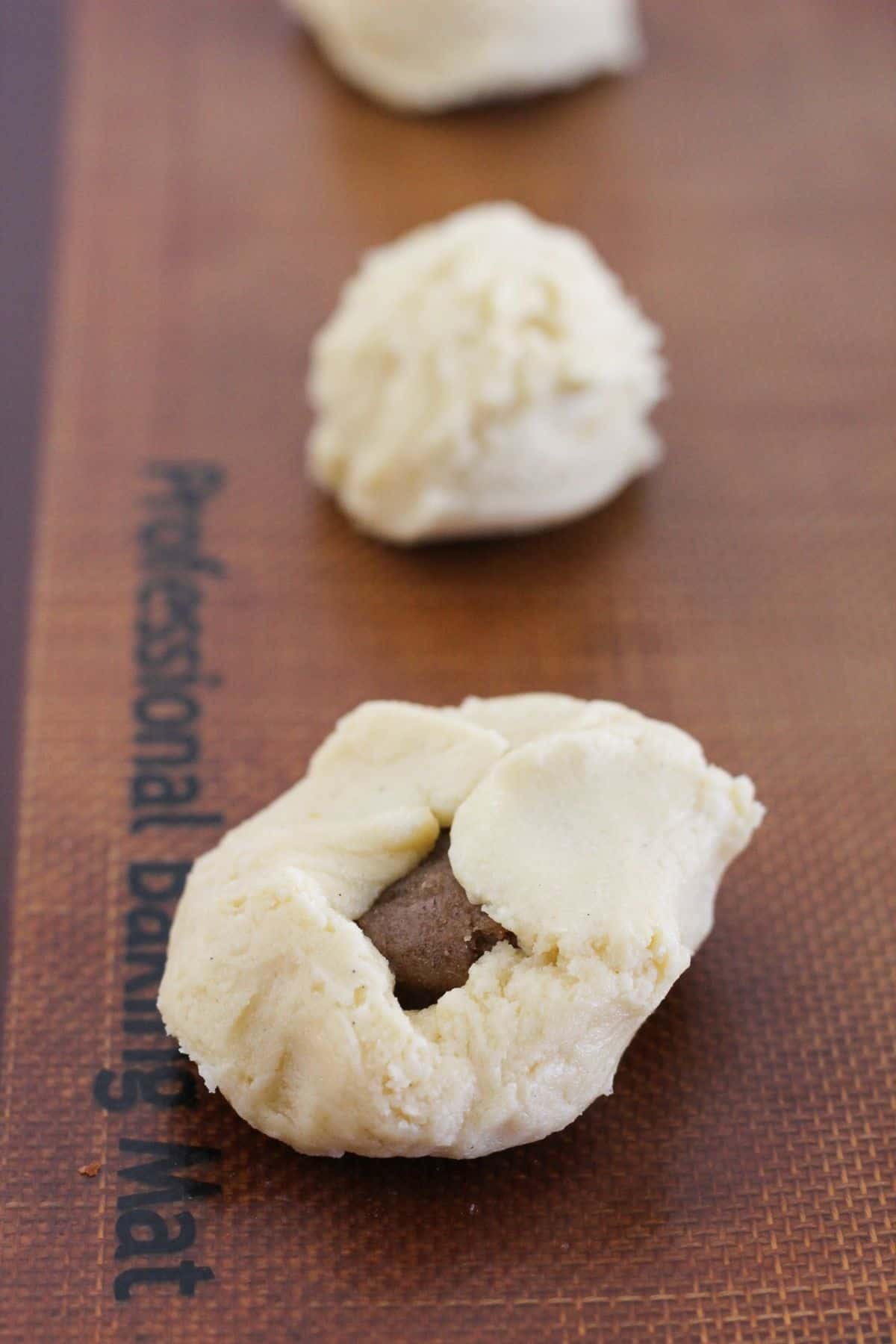 Wrapping dough around cinnamon disc.