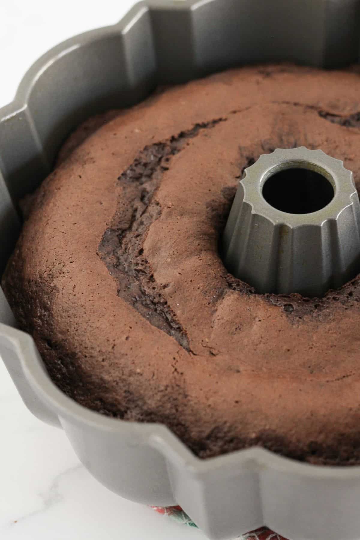 A baked chocolate bundt cake in a bundt pan.