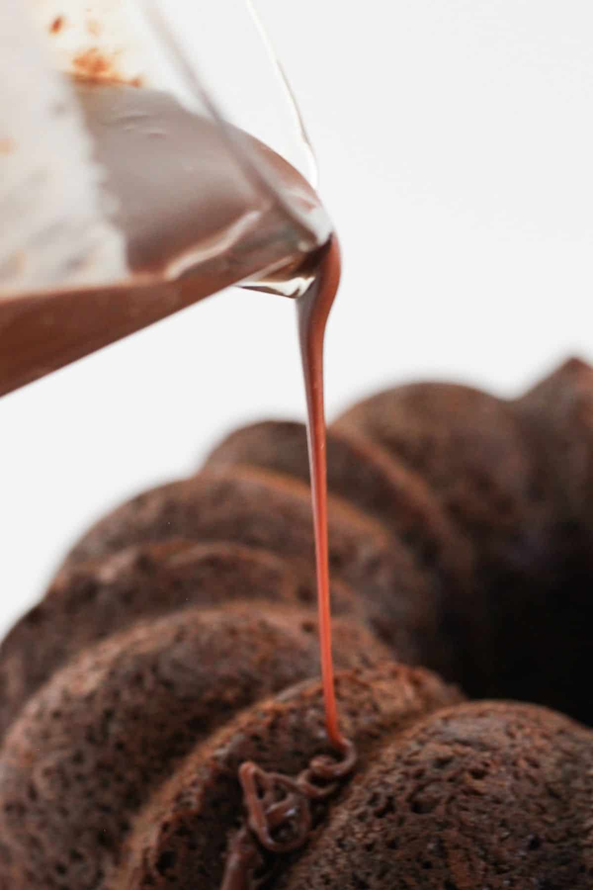 Pouring ganache to the top of a bundt cake.