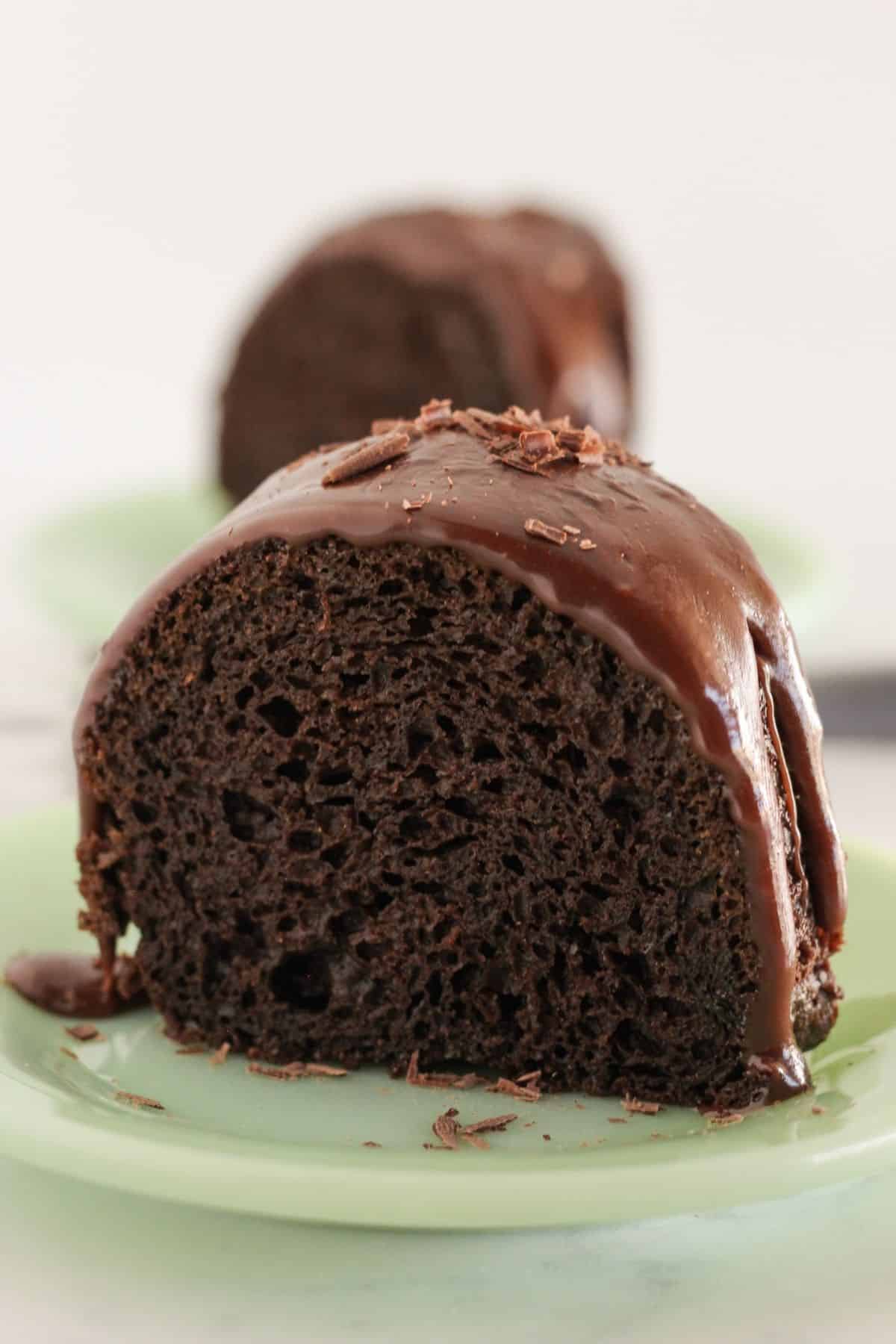 Two slices of chocolate bundt cake with ganache.