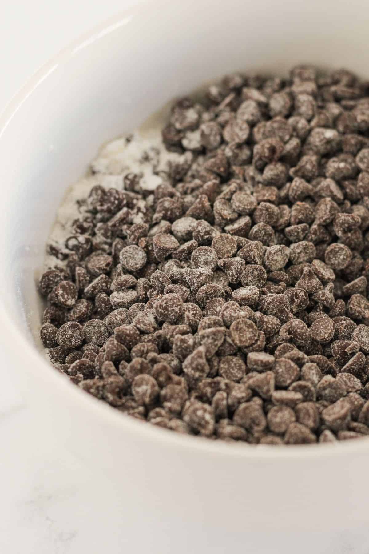 Adding cake mix to chocolate chips.