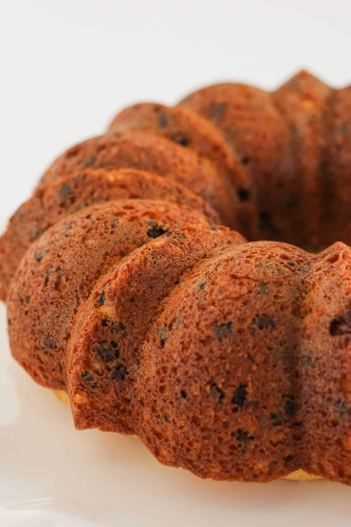 A bundt cake cooling on a cake plate.