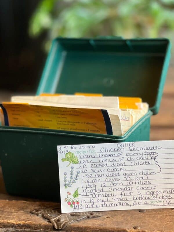 A green recipe box with handwritten recipes.
